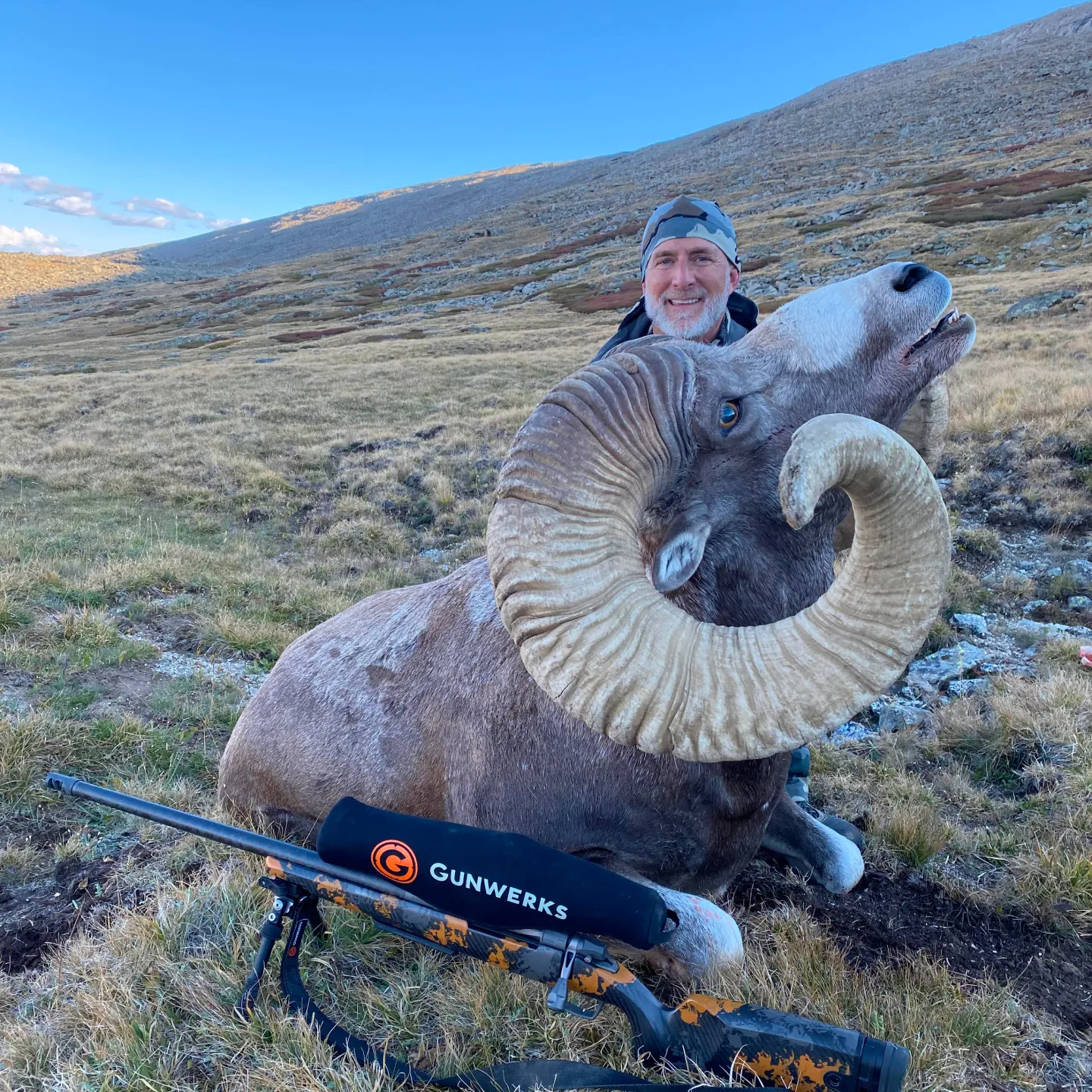 Gunwerks customer with a Dall sheep on a rocky mountainside