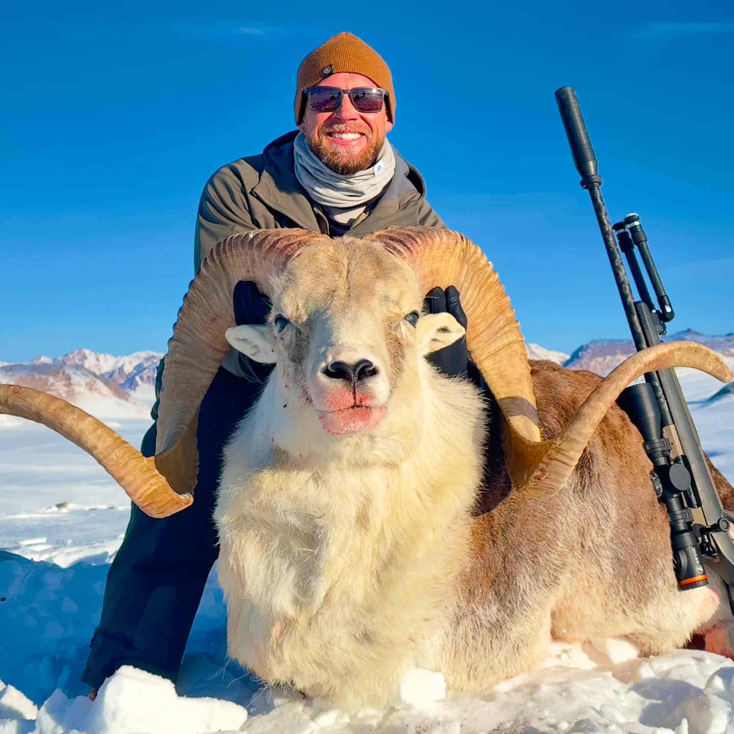Gunwerks customer with a ram in a snowy, mountainous environment