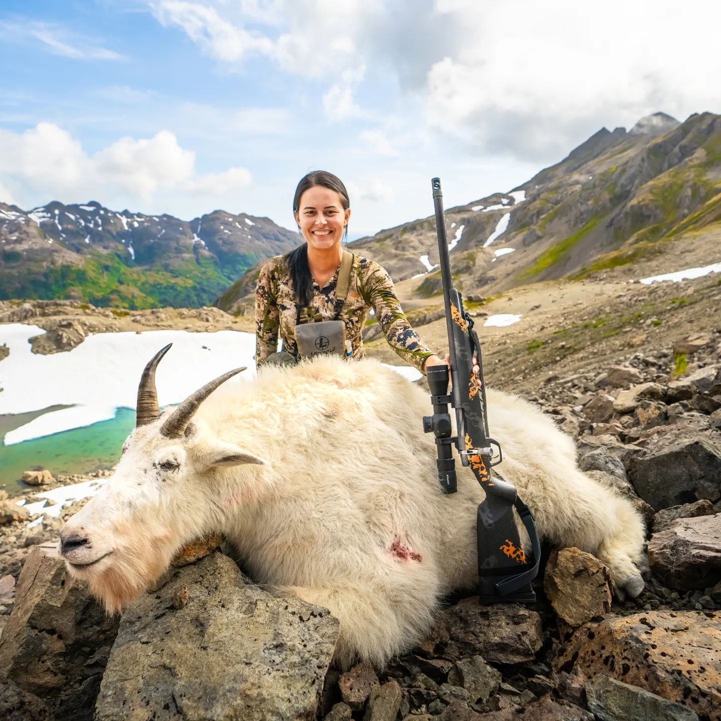 Gunwerks customer with a mountain goat in a rocky, alpine setting